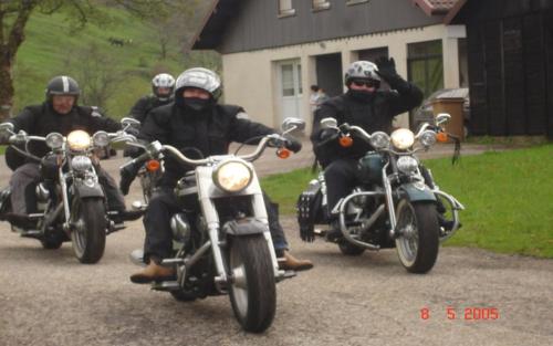 a group of people riding motorcycles down a road at Les Chantenées in La Bresse