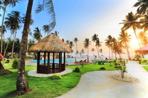 a resort with a gazebo next to a pool at Eskala Hotels and Resorts in Ngwesaung