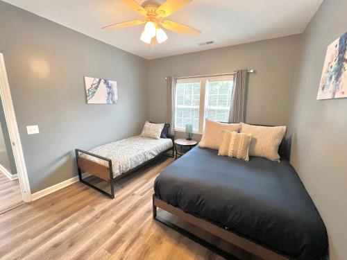 a bedroom with a bed and a window at Charming, Beautiful, Treetop Loft, Prime Location in Wilmington