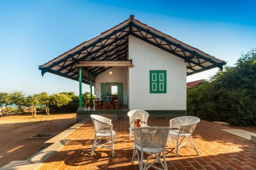 a table and chairs in front of a house at Nil Sisila Beach Resort Yala in Yala