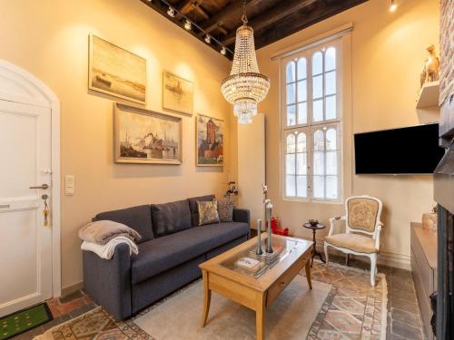 a living room with a couch and a table at Apartment in Kruibeke at Wissekerke Castle in Kruibeke