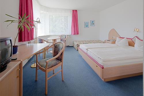 Säng eller sängar i ett rum på Hotel Jahnke