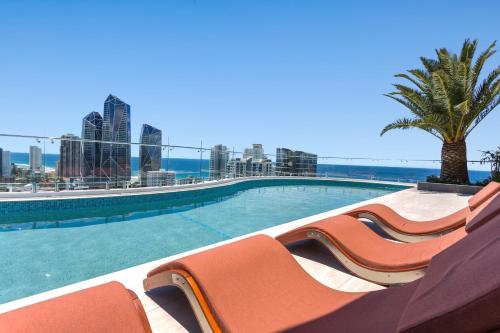 a swimming pool with a view of the city at The Gallery Residences Broadbeach in Gold Coast