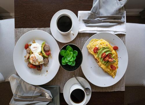 a table with two plates of food and a cup of coffee at Southey House in Kloof