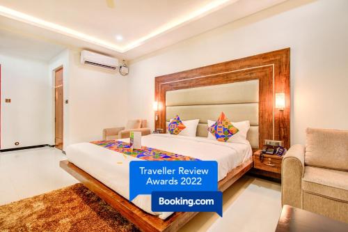 Habitación de hotel con cama y sofá en FabHotel The Royal Suites, en Bangalore