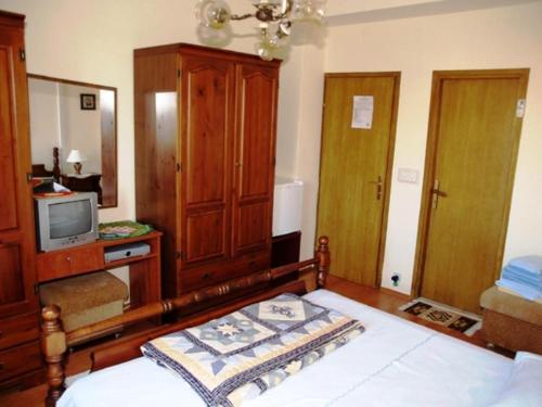 a bedroom with a bed and a tv on a cabinet at Guest House Foretić in Dubrovnik