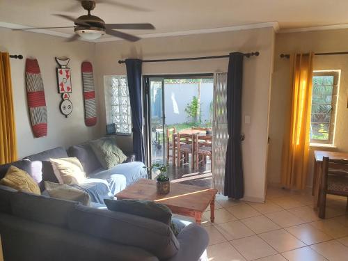 a living room with a couch and a table at Hacienda Palms in Richards Bay