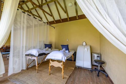 a room with two beds in a tent at Sanbonani Hotel in Hazyview