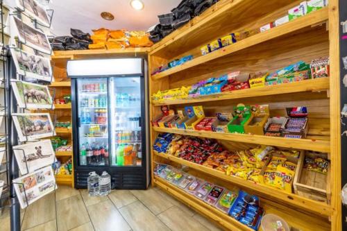 a store aisle with a refrigerator in a store at Sanbonani Hotel in Hazyview