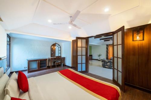 a bedroom with a bed and a living room at Country Inn Nature Resort Bhimtal in Bhīm Tāl