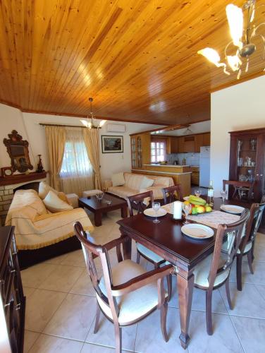 a living room with a table and chairs and a couch at Evelina house in Plátanos