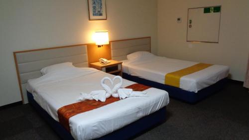 Tempat tidur dalam kamar di Ueno Frex Hotel