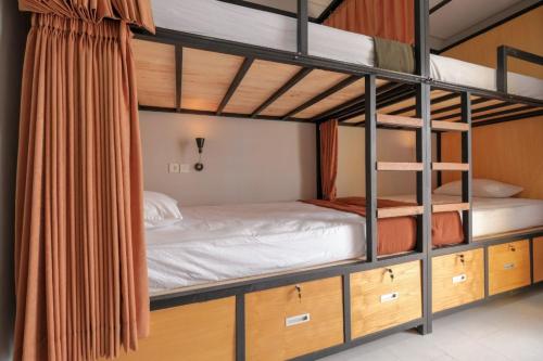 a bunk bed in a room with wooden cabinets at Canggu Castle in Canggu