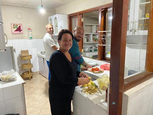 a woman standing in a kitchen preparing food at Kandy Garden Villa in Kandy