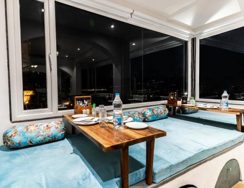 a dining room with a table and a large window at Moustache Udaipur Luxuria in Udaipur