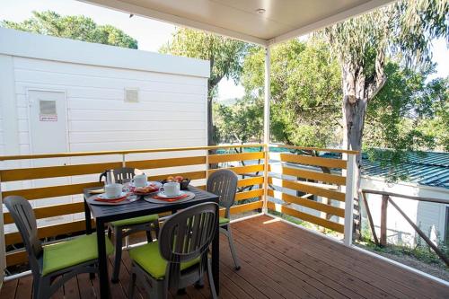 a table and chairs on the deck of a house at Camping Europa in Capoliveri