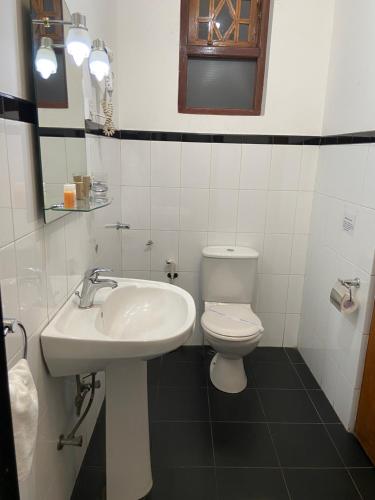 a bathroom with a sink and a toilet at Kandy Garden Villa in Kandy