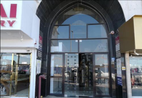 an entrance to a store with a large glass door at Golden Star Hotel in Dubai
