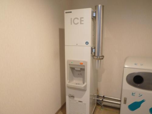 a hospital room with an ice machine in the corner at Yamagata Kokusai Hotel in Yamagata