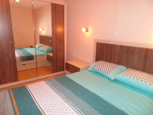 a bedroom with two beds and a large mirror at Apartments Marina in Kotor
