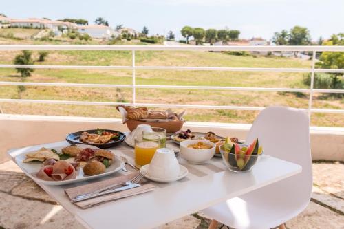 a tray of breakfast food on a table on a balcony at bed&breakfast Filomare in Numana