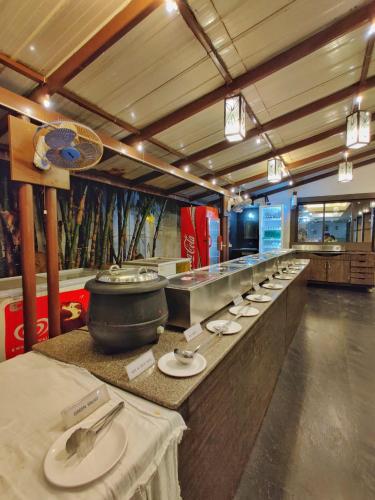 a buffet line with a large pot on a counter at Hotel Ashwin Igatpuri, Pure Veg & Jain Food in Igatpuri