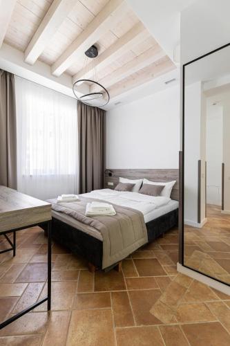 a bedroom with a large bed and a mirror at Oysters & Bubbles Gastro Hotel. Rynok square in Lviv