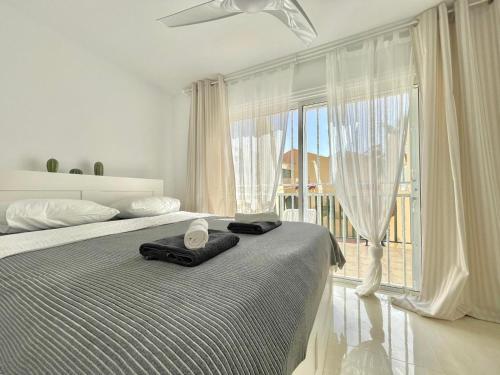 a bedroom with a bed and a large window at Casa Drapa Costa Adeje in Adeje