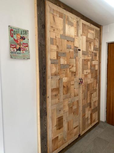 a wooden door in a room with a wall at Chèvres à Cheval - Apartment in Aosta