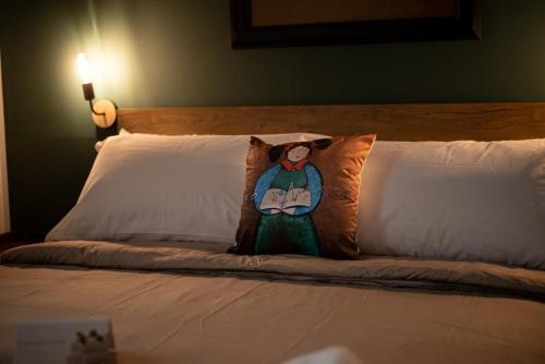 a bed with a pillow with a woman on it at LE MADAMINE ROOMS in Turin