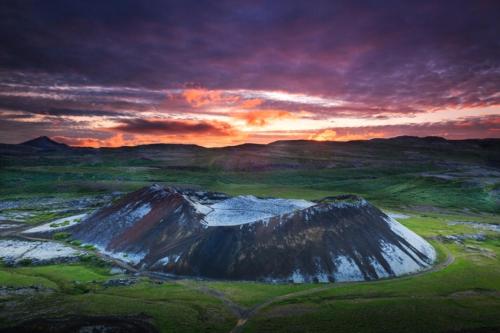 a painting of a mountain with a sunset in the background at Beautiful house in the nature of West Iceland in Borgarnes