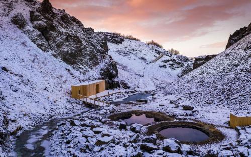 a snow covered mountain with two ponds in the middle at Beautiful house in the nature of West Iceland in Borgarnes