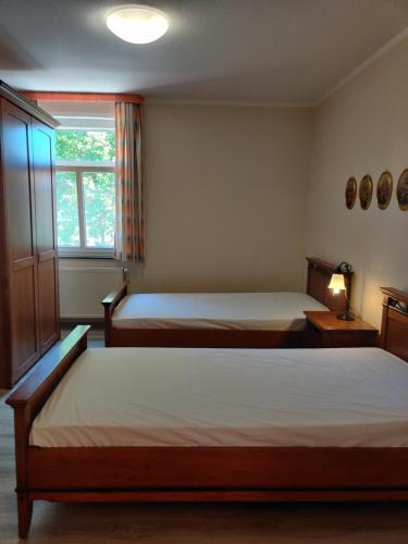 a bedroom with two beds and a window at Hotel LG Wolfsburg in Wolfsburg