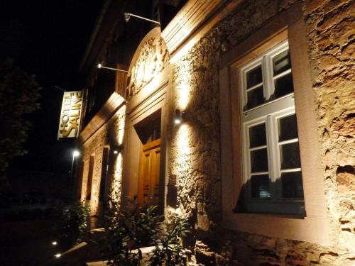 a building with a wooden door at night at Hotel Saline 3-Sterne Superior in Büdingen