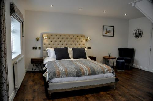 a bedroom with a bed and a chair and a window at Upstairs at 33 - Self check in boutique accommodation in Worcester Centre in Worcester