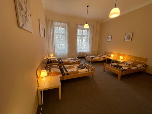 a room with three beds and candles in it at Hostel U Sv. Štěpána in Litoměřice