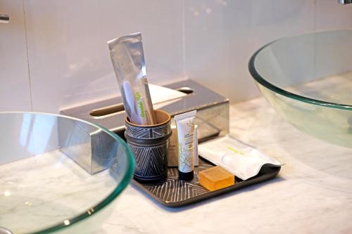 a counter with a container of soap and a glass bowl at Bab Hotel in Marrakech