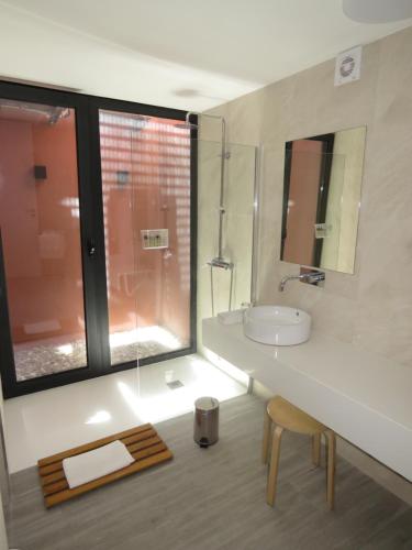 a bathroom with a sink and a glass shower at Paco de Pombeiro - Turismo de Habitacao in Felgueiras