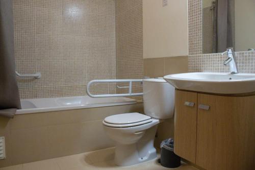 a bathroom with a toilet and a sink and a tub at Apartamento Margarida Royal Cabanas Golf By Your Home Algarve in Tavira