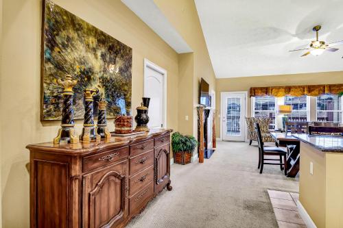 a living room with a large wooden cabinet with vases on it at Villa Vista in Hollister