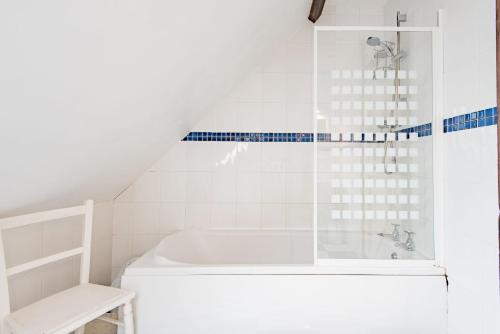 a white bathroom with a tub and a sink at The Old Schoolroom by Bloom Stays in Canterbury