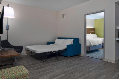 a room with a bed and a mirror at Holiday Inn Express North Myrtle Beach - Little River by IHG in Little River