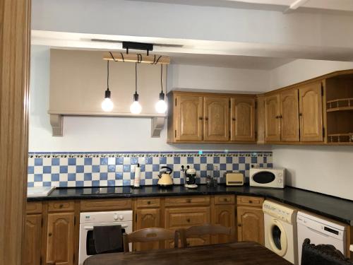 a kitchen with wooden cabinets and a counter top at La casa Trivala in Carcassonne