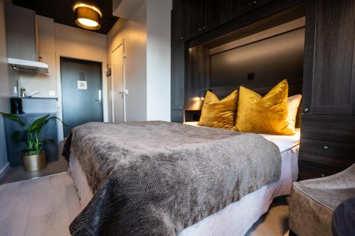 a bedroom with a large bed with yellow pillows at Wilhelmsen House in Tønsberg