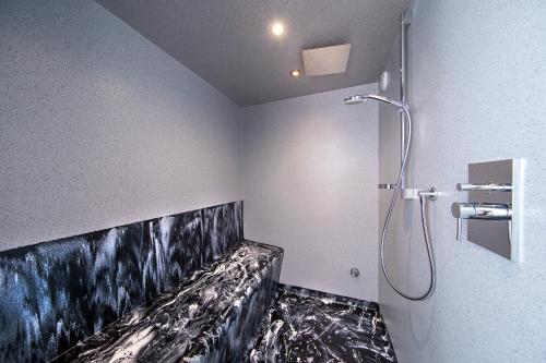 a bathroom with a black and white painting on the wall at Bergblick Apartment in Wald im Pinzgau