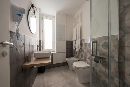 a bathroom with a toilet and a sink and a shower at Casta Diva Luxury Apartments -Self check-in in Palermo