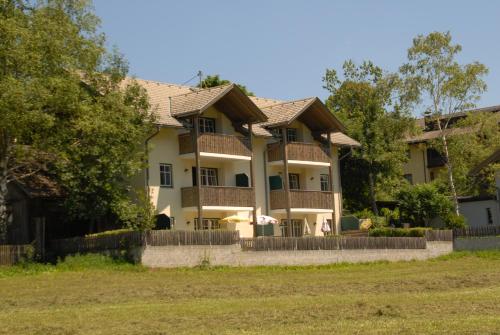 a large house with a fence in front of it at Ferienwohnungen Forellenhof Waldner in Gundersheim