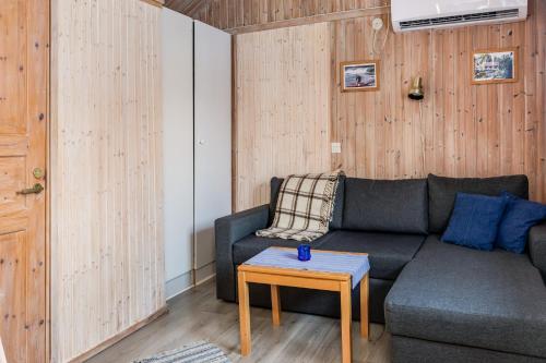 a living room with a couch and a table at Hyttgårdens stugby i Huså, Åre kommun in Järpen