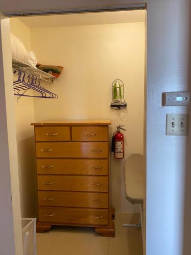 a closet with a wooden dresser in a room at Dawn’s Comfort Zone in Kingston