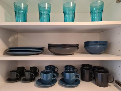a row of blue cups and plates on shelves at revLIVING Apartments Eggenburg in Eggenburg